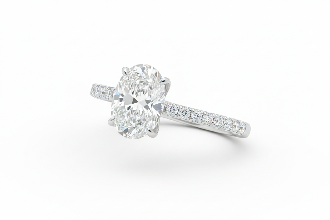 Side stone engagement ring with pavé band and center diamond
