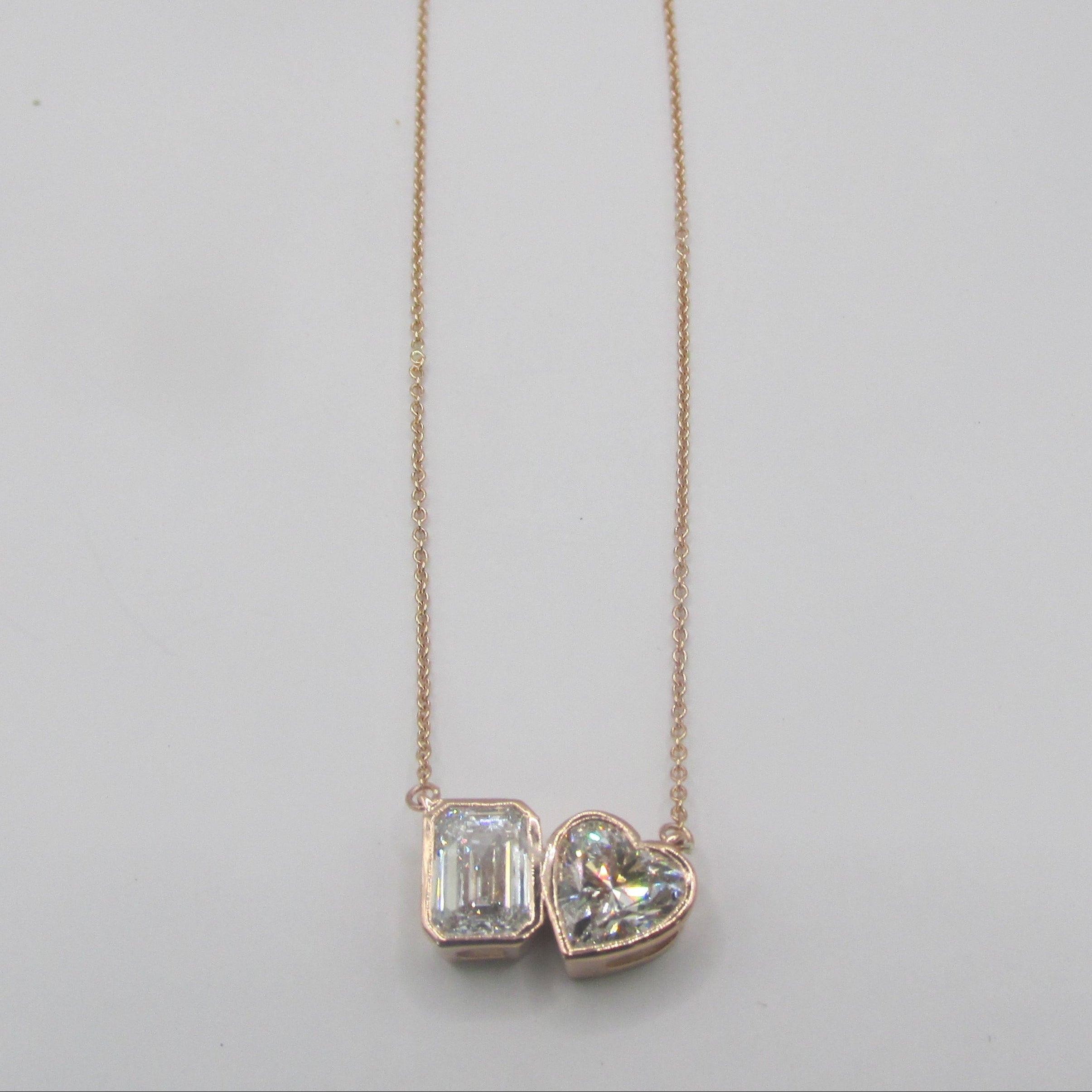 Close-up of a 2.87 carat total weight (CTW) Lab-Grown Diamond Toi et Moi Necklace set in 14K Rose Gold, featuring two distinct cuts of diamond (e.g., pear and cushion) side-by-side, symbolizing two souls
