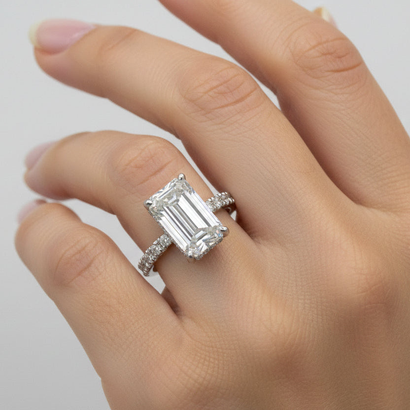 Emerald cut lab-grown diamond engagement ring on hand