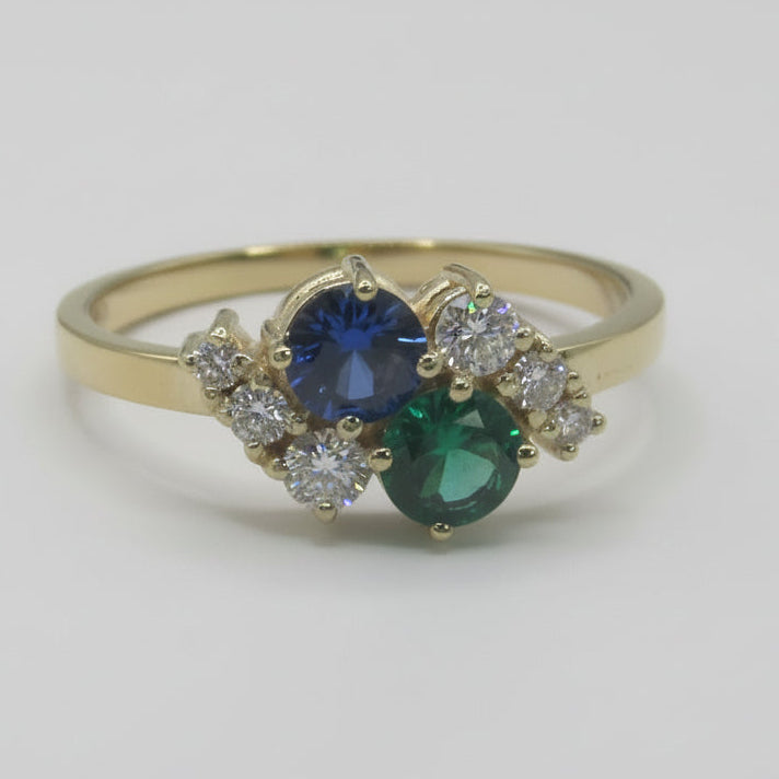 Lab-grown emerald and sapphire toi et moi ring in 14K yellow gold with diamond accents