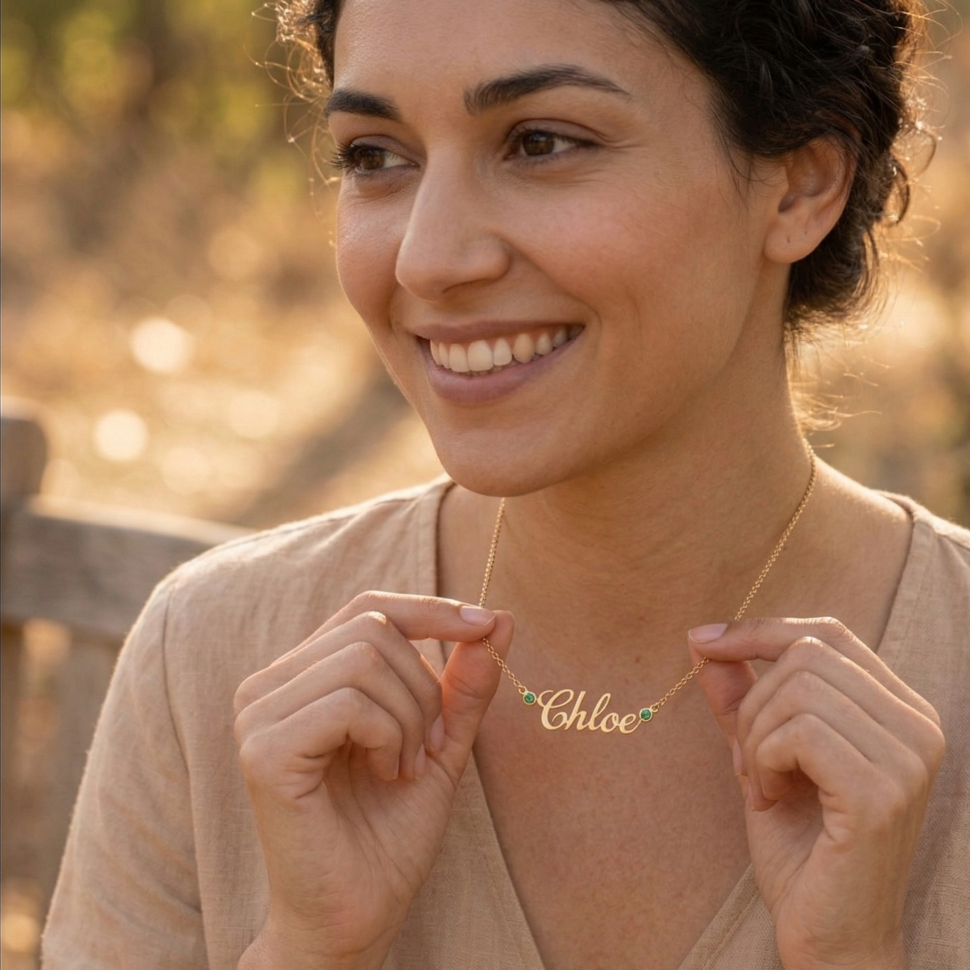 Yellow gold necklace with emerald accents featuring a "Chloe" pendant