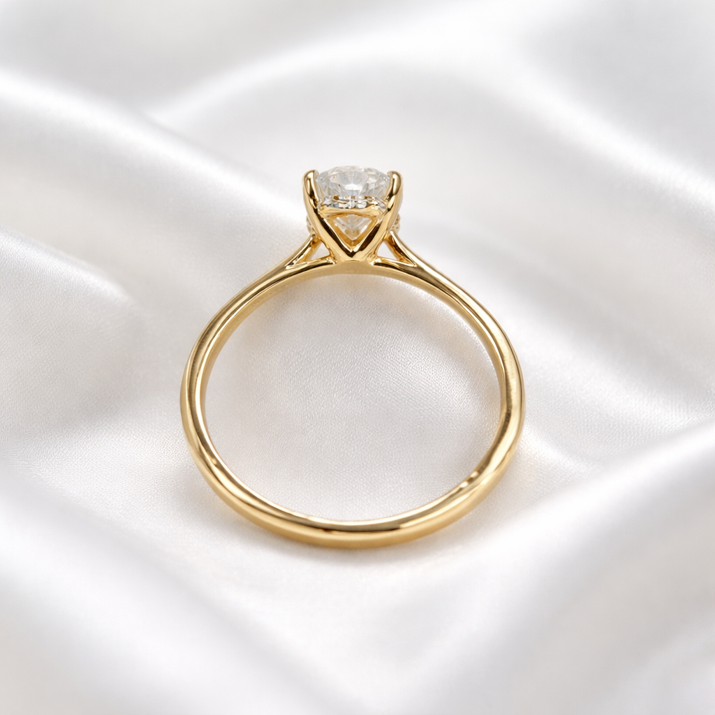 Hidden halo detail under pear diamond engagement ring in 14K yellow gold
