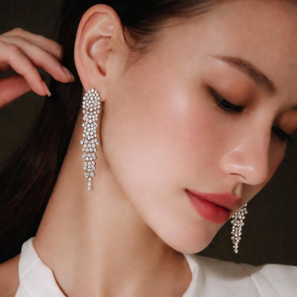 close-up of diamond drop earrings on a woman, Sofia