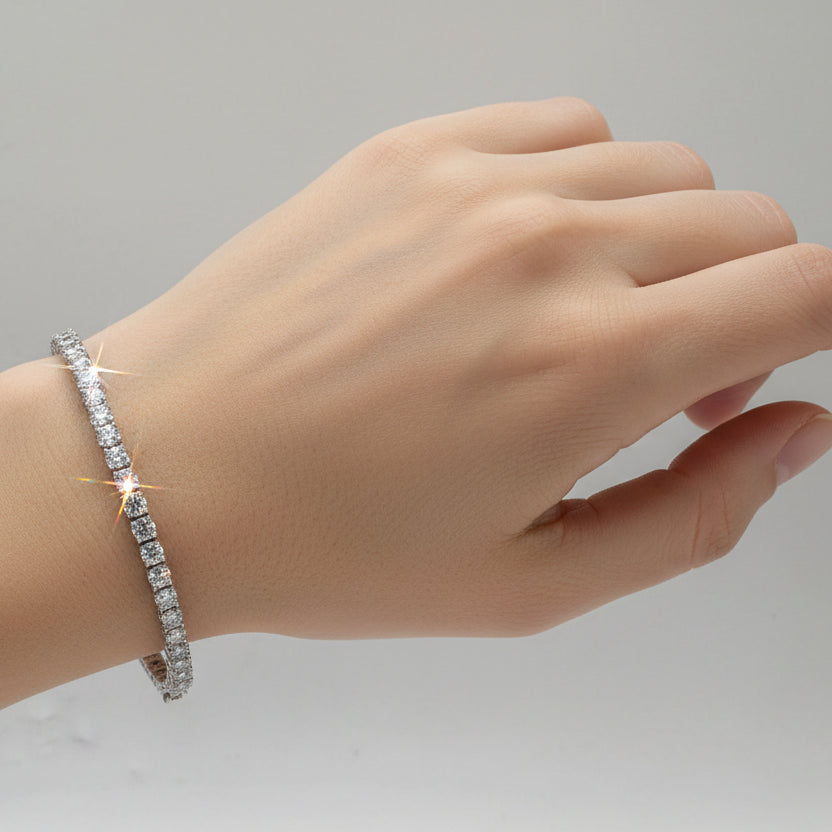 A hand wearing a sparkling bracelet 