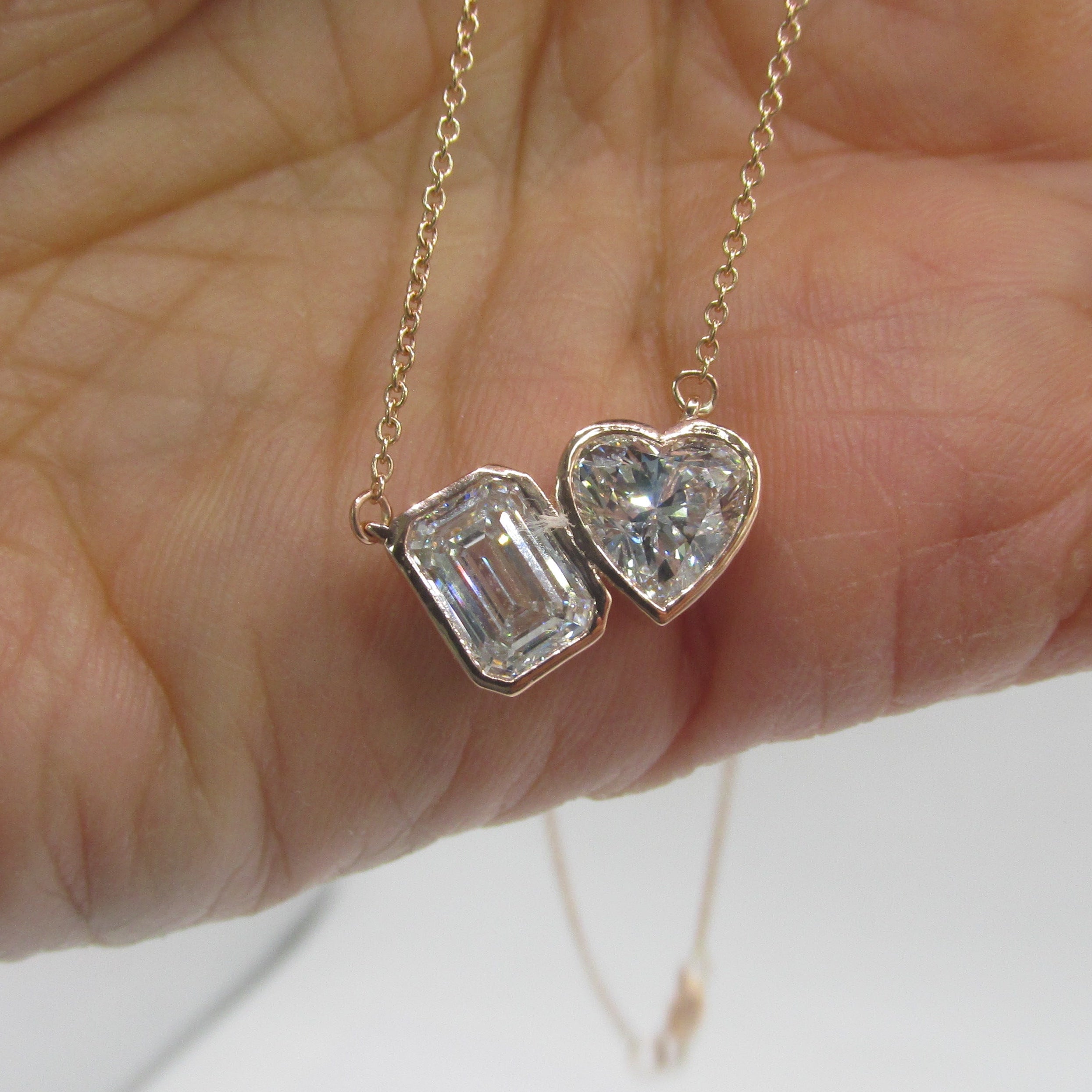 Close-up of a 2.87 carat total weight (CTW) Lab-Grown Diamond Toi et Moi Necklace set in 14K Rose Gold, featuring two distinct cuts of diamond (e.g., pear and cushion) side-by-side, symbolizing two souls