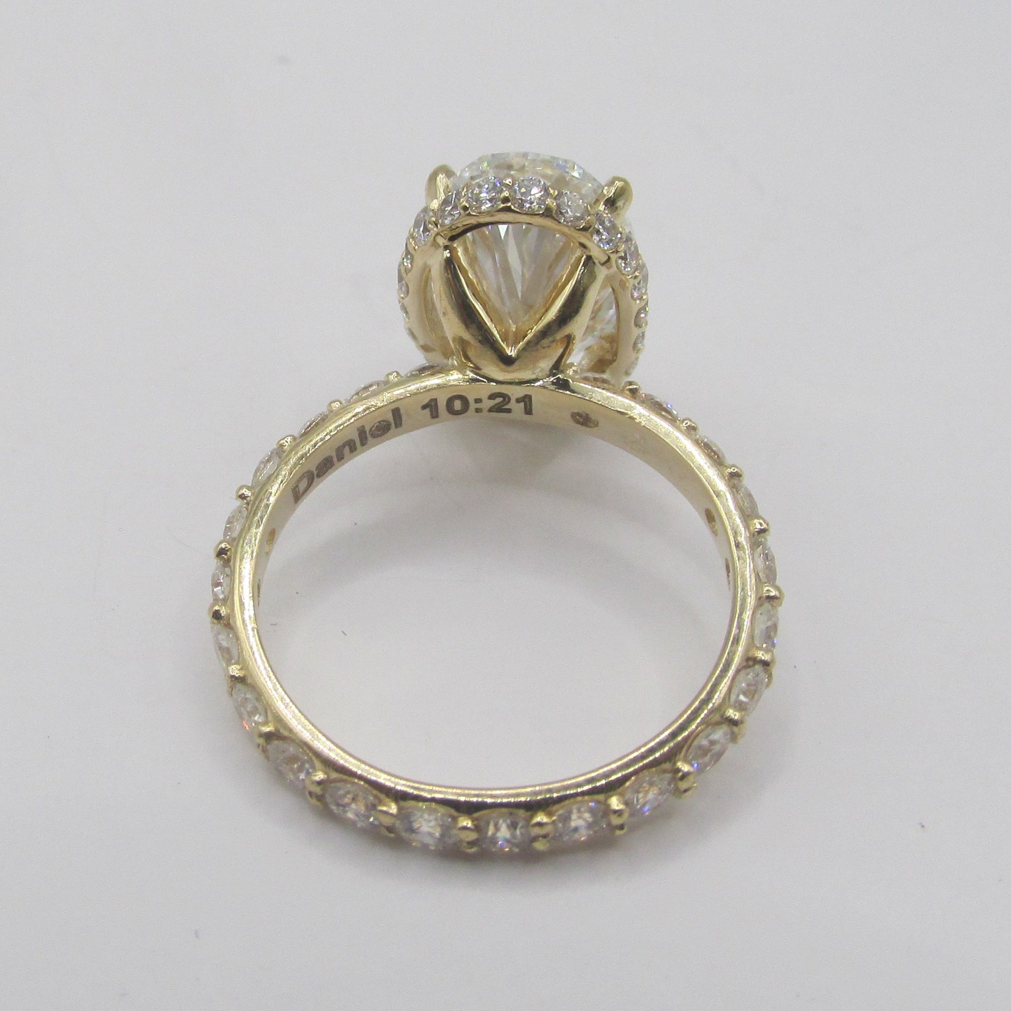 Side view of custom 14K Yellow Gold setting for Oval Lab Diamond ring on light background