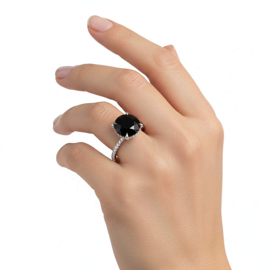 Close-up of a woman wearing Carrie's Black Diamond Engagement Ring